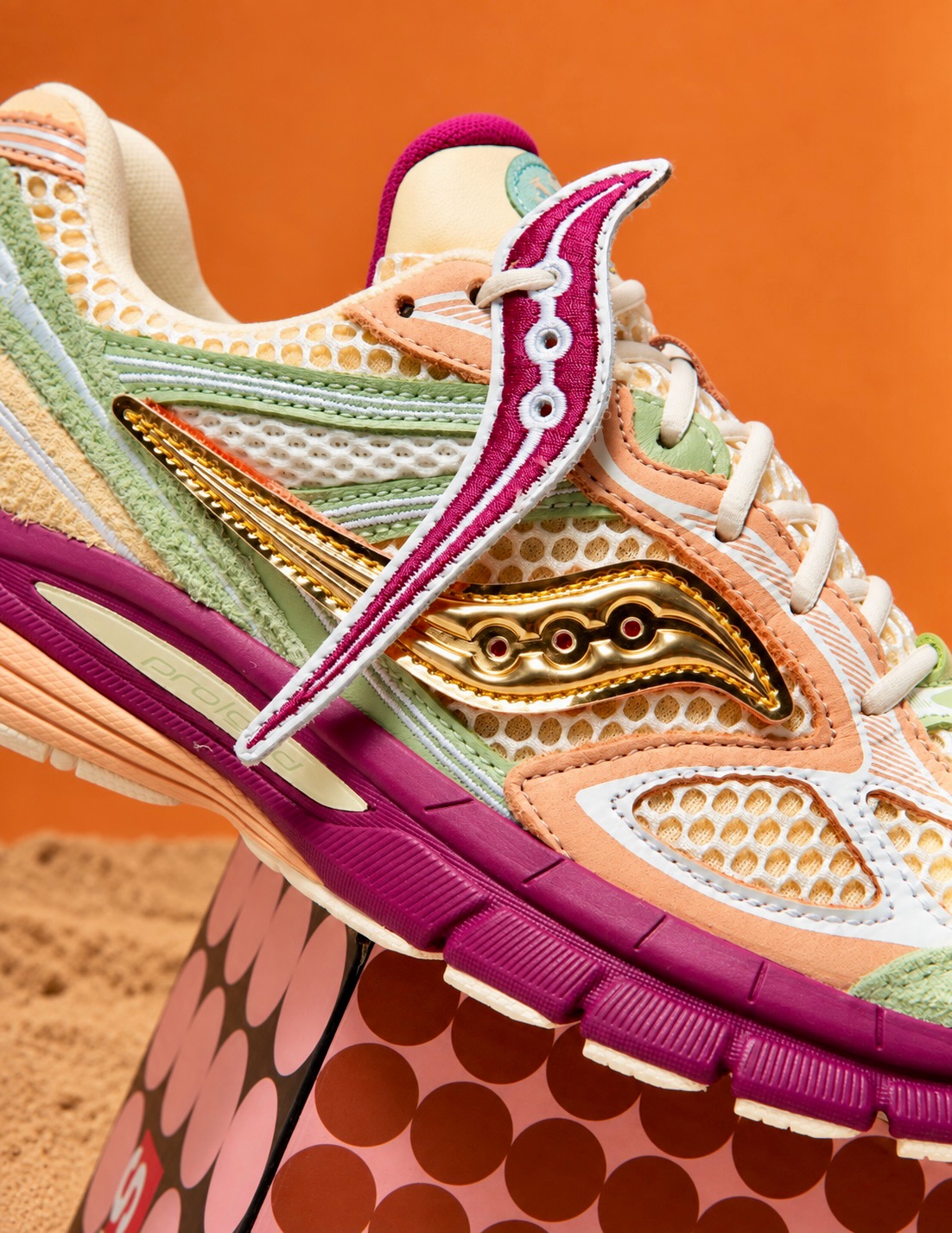 Close-up of the Saucony x Stan Birch ProGrid Guide 7 showing the swappable velcro logos and laces