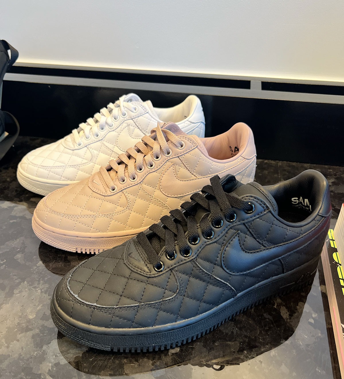 Nike Air Force 1 Low Quilted in all-white, all-black and rosy tan side by side