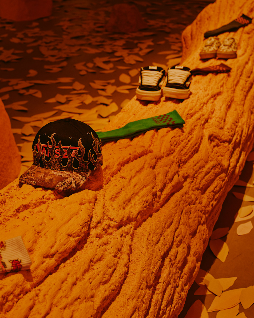 Vansza cap and Knu Skool Mule staged on a tree stump at the activation