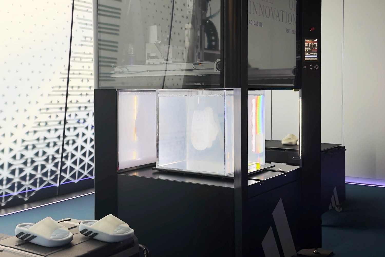 The adidas Climacool Recovery Slides next to the Rapid Liquid Printing machine at the adidas Home of Innovation event