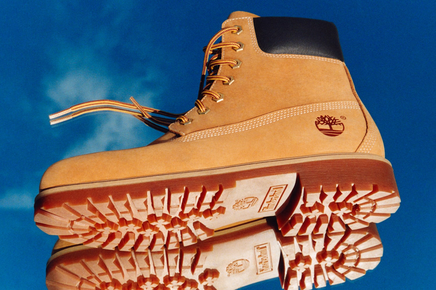 Timberland 25 6-Inch Waterproof Boot in Yellow against a blue sky