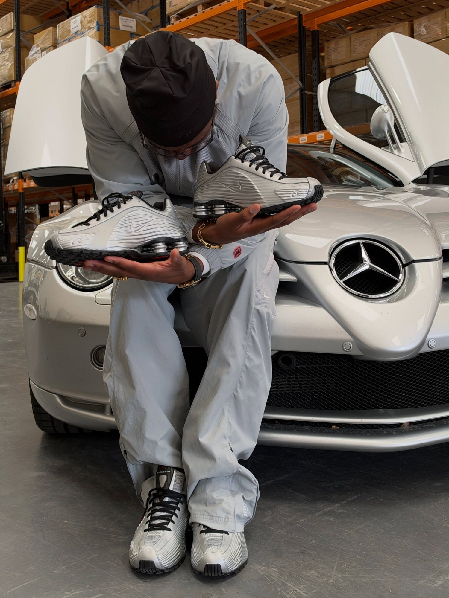 Clint419 holding the Corteiz x Nike Shox R419 Metallic Silver