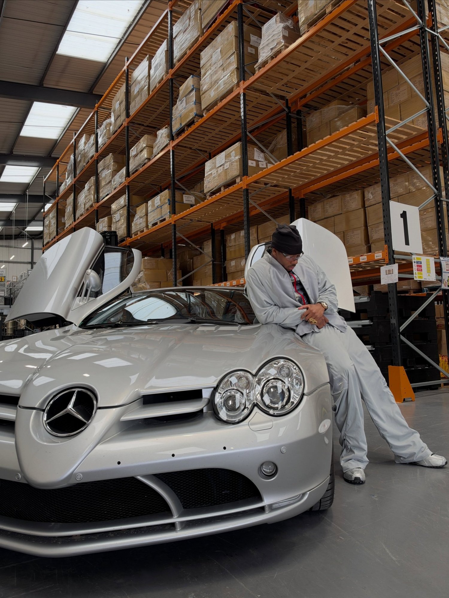Clint419 sitting on a silver Mercedes SLR