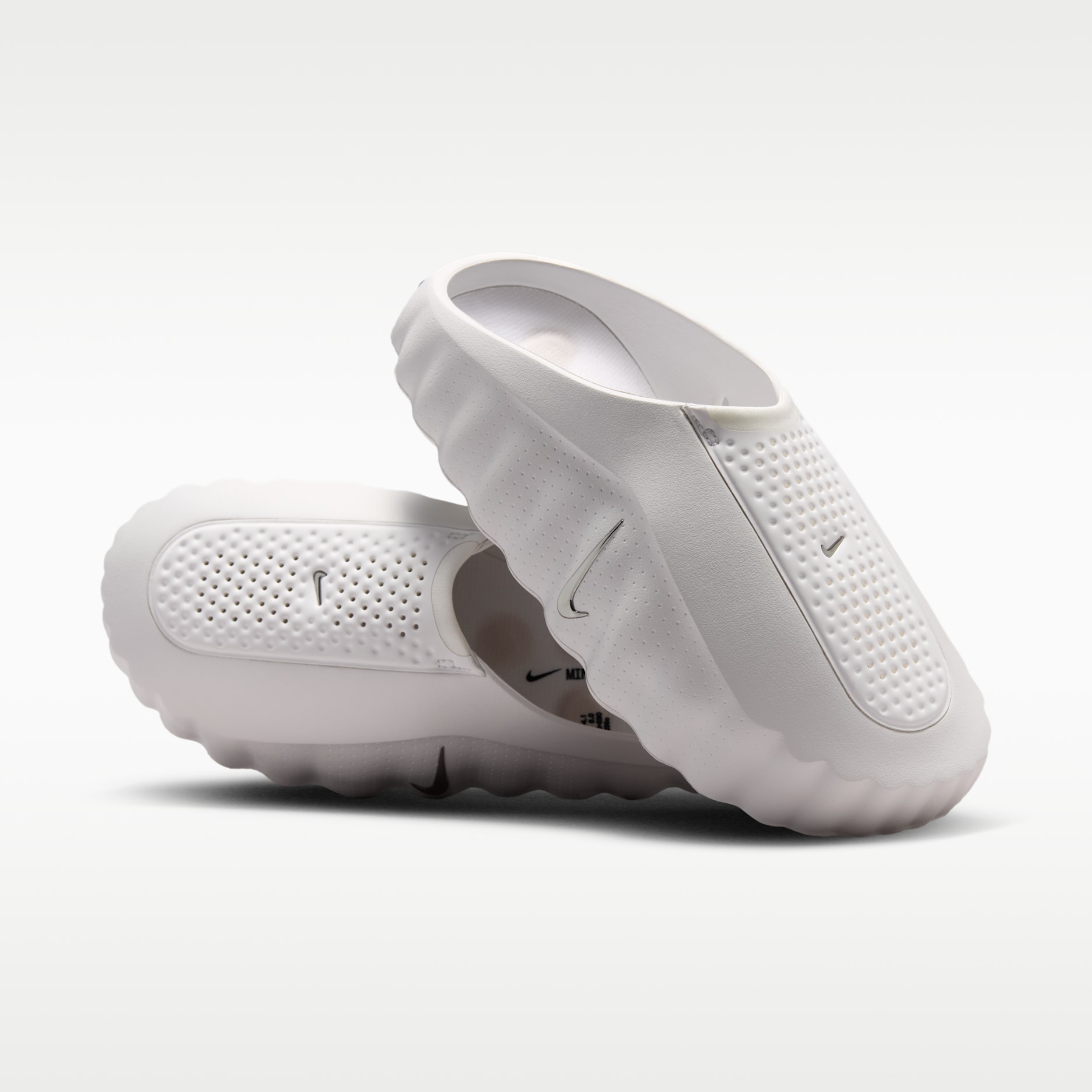 Nike Mind 001 Summit White slides, angled view