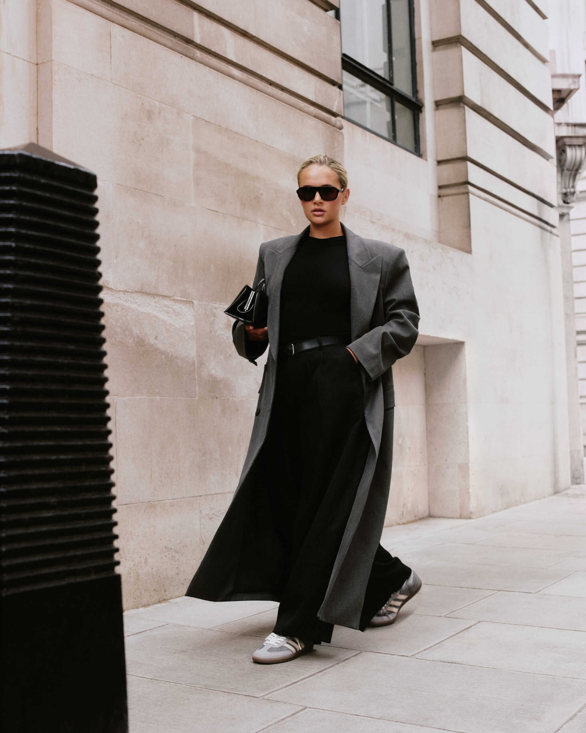 Molly-Mae in a long black coat wearing the adidas Samba Slate