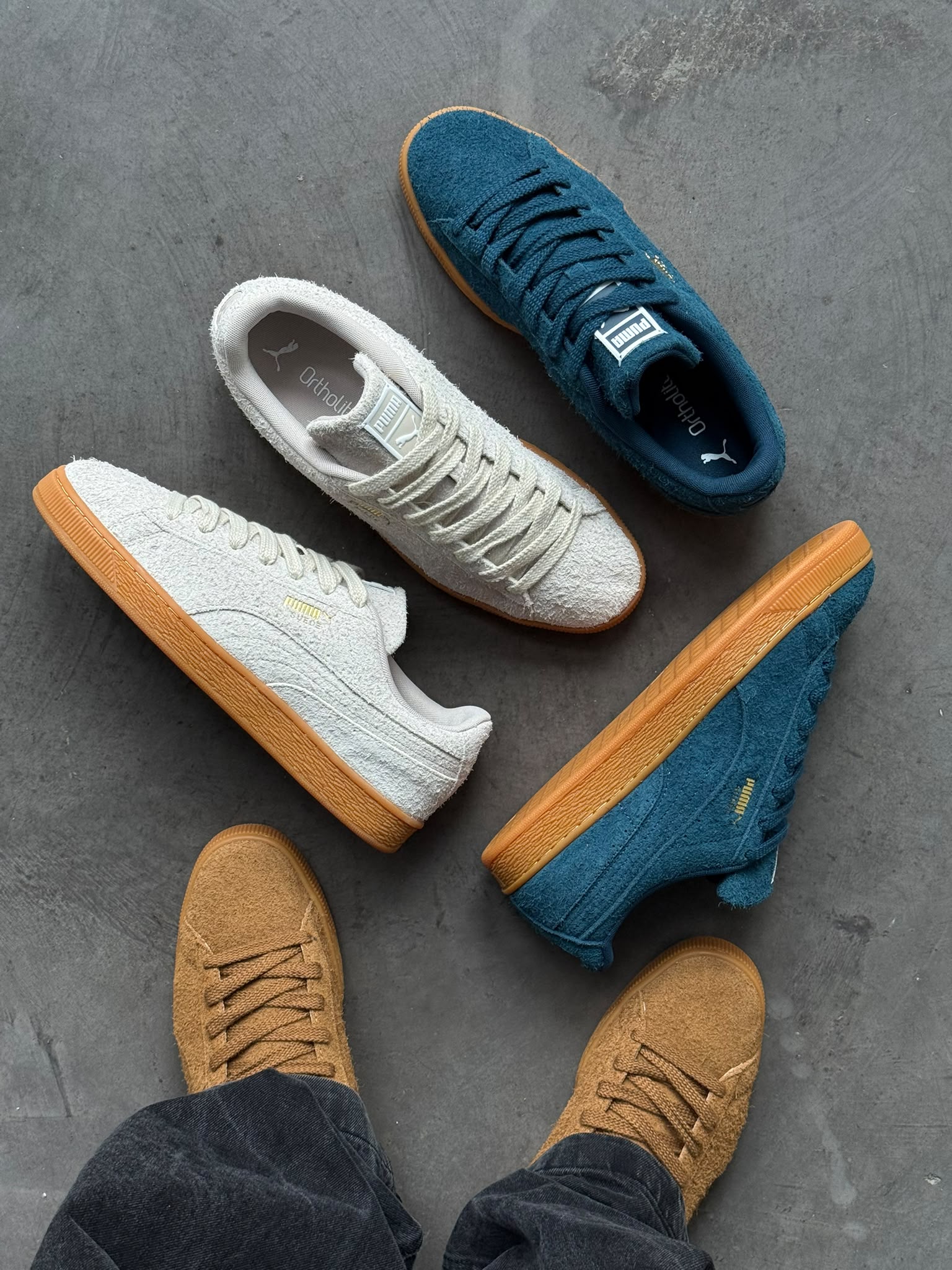 PUMA Suede Forever Kona Brown on feet next to Midnight Petrol and Silver Fog
