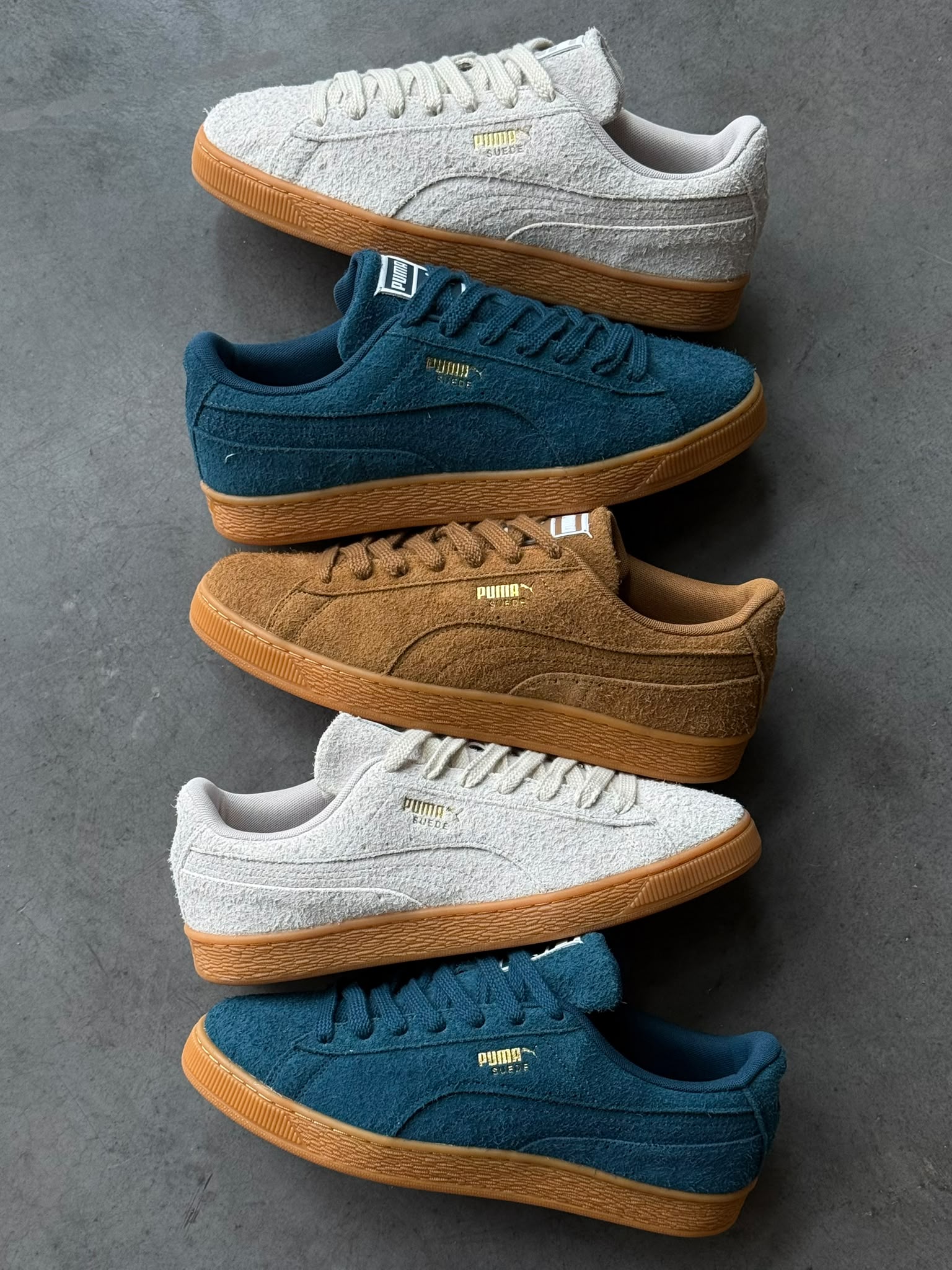 Stack of PUMA Suede Forever pairs in all three colourways