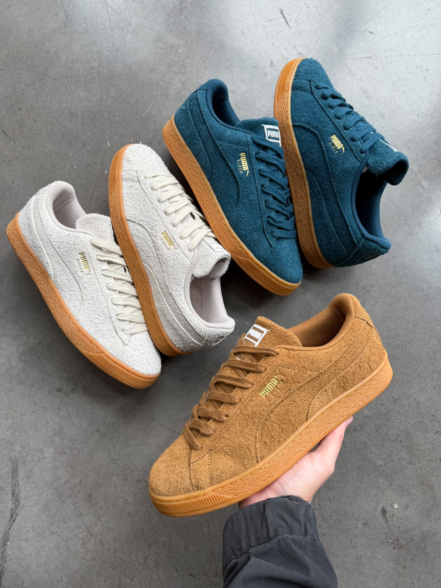 PUMA Suede Forever Kona Brown held in hand