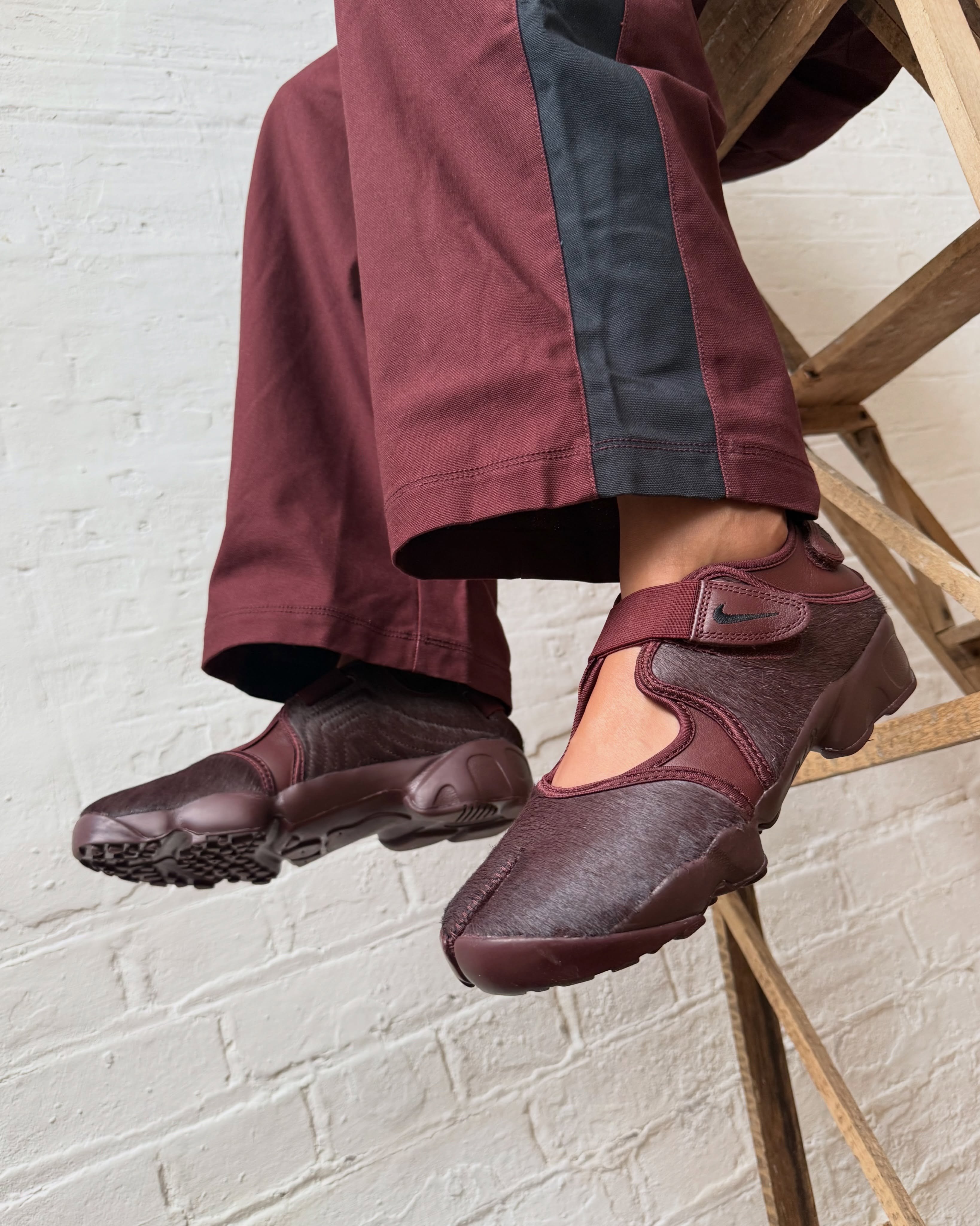 Nike Air Rift Mystic Dates pony hair on feet with burgundy trousers