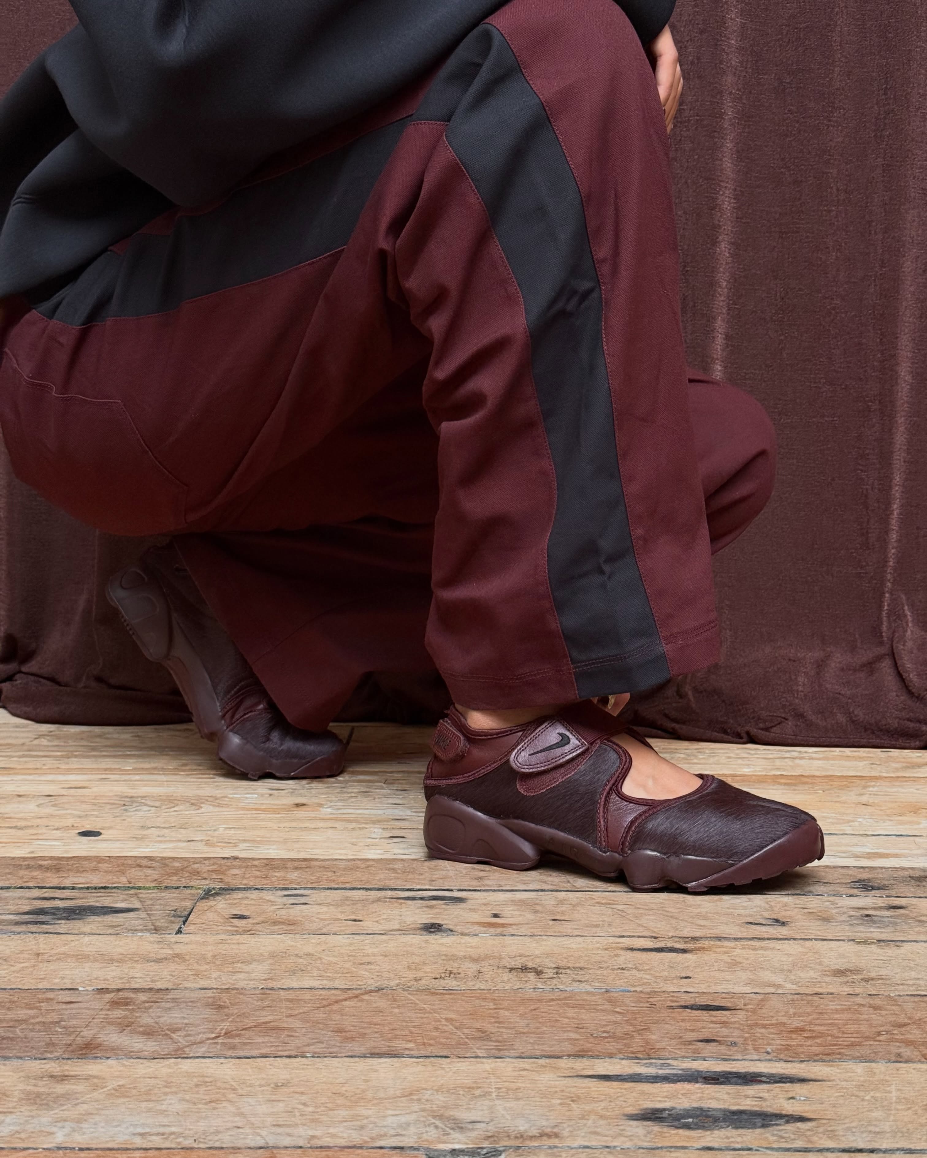 Nike Air Rift Mystic Dates worn with burgundy trousers