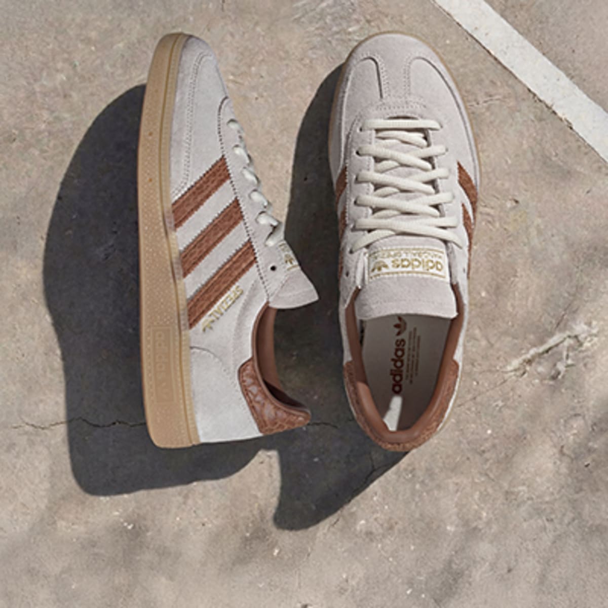 Helle Sneaker mit braunen Streifen und Gum Sole auf Beton