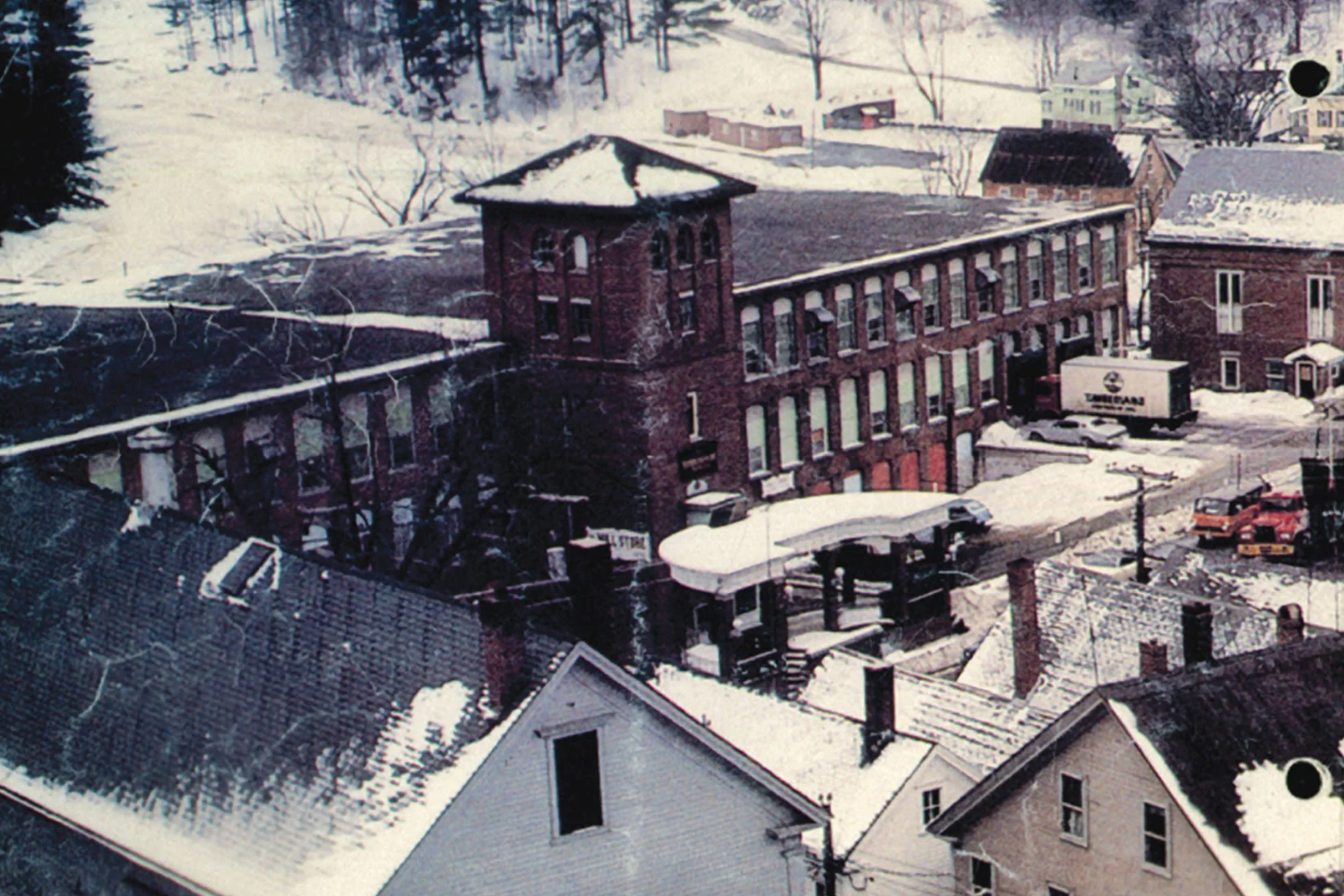 Snow-covered brick factory complex viewed from above, showing early industrial footwear production facilities. Abington Shoe Company.
